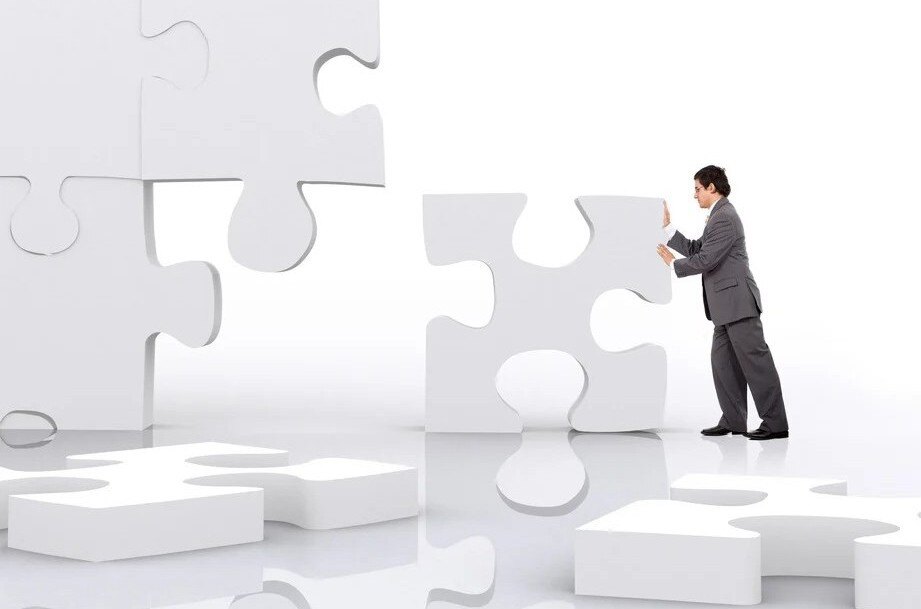 business man implementing a piece of a puzzle-2